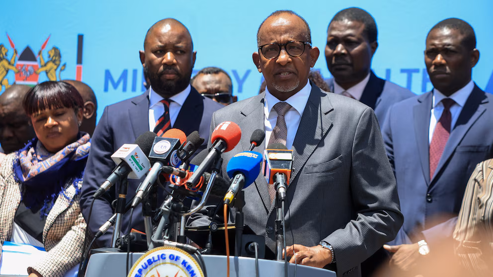 Kenya's Cabinet Secretary in charge of Health breaking the news in a news conference.